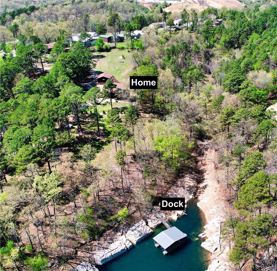 Experience the ultimate lake lifestyle in this cozy, rustic 2,450 sqft cabin on the north end of Beaver Lake. Situated on 1.68 acres across two parcels, this property features a gentle 6-ft easement leading to your private single-slip boat dock with a lift in a quiet cove. The home boasts a 2024 roof and freshly stained cedar exterior. The interior shines with refinished oak hardwood floors, tongue-and-groove ceilings, and cedar-trimmed windows. The main level offers a kitchen with custom oak cabinets and Corian counters, a dining area with cathedral ceilings and a wood stove, and a bright living room with walls of windows overlooking the lake. The layout includes a main-level bedroom and full bathroom. A spacious loft with skylights and a half bath can be found on 2nd level. While a walk-out basement features a third bedroom and a full bath with a cast iron clawfoot tub and a cedar-lined walk-in closet. Complete with a detached 2-car garage and wrap-around porch, this private retreat is lake living at its finest.