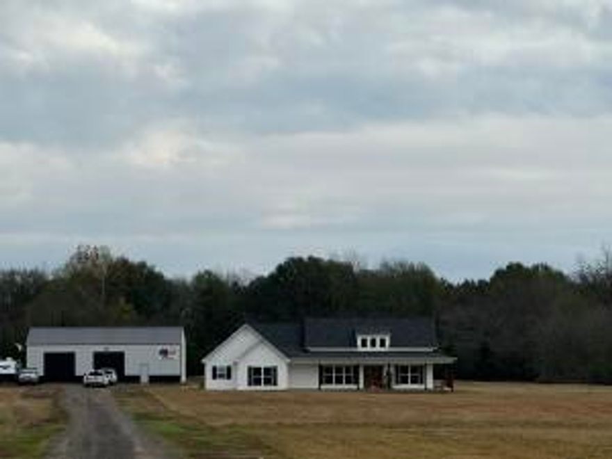 43 acres of picturesque land, this stunning 2 1/2-year-old home is a true sanctuary for those seeking space, privacy, & modern comforts. The property boasts a serene pond brimming with fish.  Cozy up by the fireplace during chilly evenings & relish in this 3 bedroom / 2.5 bath home.  Itself showcases contemporary design, featuring foam insulation for optimal energy efficiency and an 18 SEER HVAC system to ensure comfort throughout the seasons.  Safety and security are paramount, with security system, a secure gated entrance, and a fortified safe room designed for peace of mind.  The impressive 40 x 60 shop with 12-foot walls offers endless possibilities for hobbies or storage, complete with separate electrical service for added convenience.