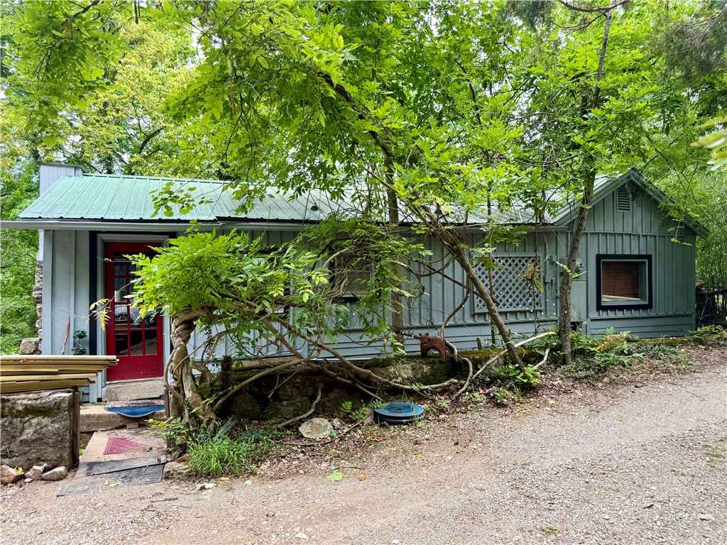 Overlook Downtown Eureka Springs in this beautiful wooded setting. Located in sought after Historic Eureka Springs on a hidden side street, just 3 blocks to downtown shops and restaurants. Enjoy the abundance of song birds, squirrels, and the neighborhood family of deer that call this area their home. Fresh exterior paint, new washer and dryer, new refrigerator. Wood floors throughout, large soaking tub in addition to stand up shower. Enjoy the view of the Crescent hotel from the private hot tub in the backyard. Hard to beat this call today for your to schedule your showing.