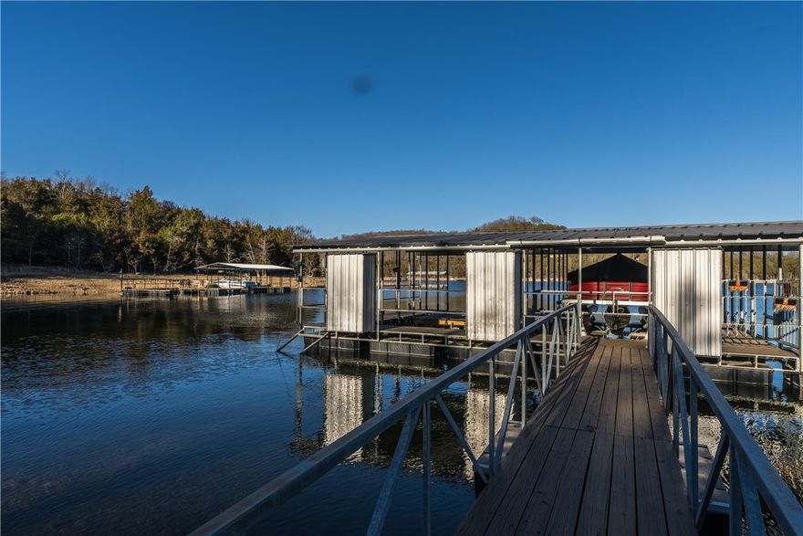 That lake home you've been dreaming of all winter long, has officially hit the market!! 
A scenic and quick 10 mile drive from Highway 62, you will find this recently updated, one level lake front home sitting on an oversized flat lot over looking the beautiful Beaver Lake. It's an easy, level walk to your co-owned boat dock with 2 slips, 2 boat lifts & 3 lockers. It has everything you need to make this summer a memorable one! This home is move in ready with fresh paint, luxury vinyl plank flooring throughout, new granite countertops, & light fixtures. If you're needing some more storage, across the street from the home is a 1800 sq ft metal shop with 30 amp serv, water & electric for an RV, and another 24x30 Garage. 
This property is perfect for your weekend getaway or your next short term rental investment (or maybe both) - You need to come see these views for yourself!
