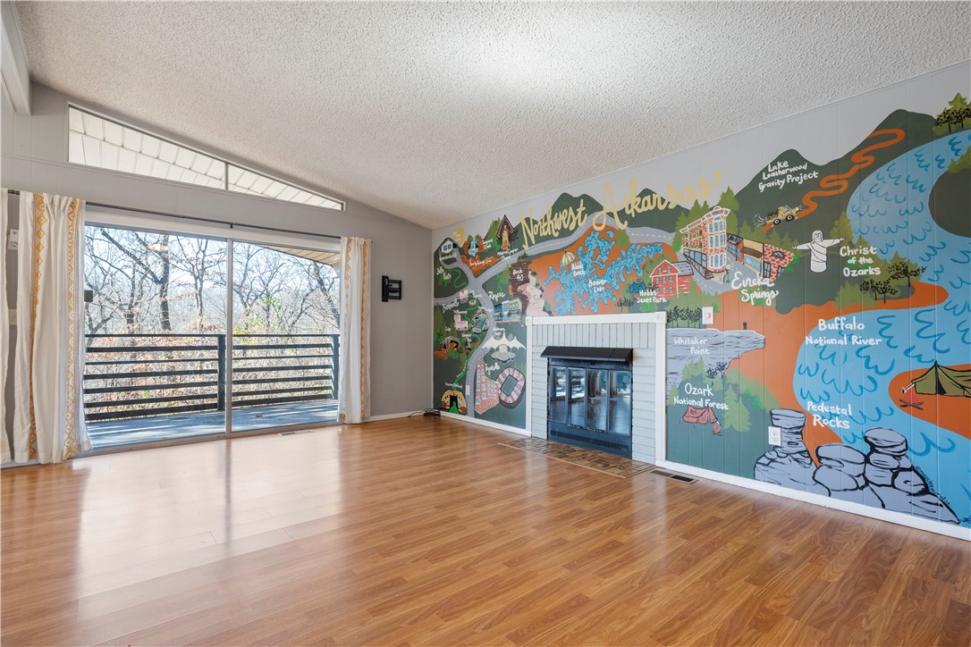 Sellers are offering a concession towards the windows. It's a charming 3 bedroom, 1.5 bathroom house, situated in the tranquil, quiet neighborhood of Bella Vista with a stunning view from the large deck. On cold days you can enjoy the view from anywhere in the open floor plan that has dual sliding doors and tons of natural light. This house has everything you are looking for, including one of a kind mural of Northwest Arkansas by a local artist. The house boasts a cozy and comfortable atmosphere, making it the perfect place for you to call home. Close to 279 or 71 for easy commute, minutes to shopping, restaurants, trails, and let's not forget Lake Avalon. Schedule a viewing today to see for yourself what this amazing property has to offer, don't forget to check the attached workshop/storage, plus the additional storage under the deck! Roof approximately 4 years old, propane tank is owned and was pumped in 2022.