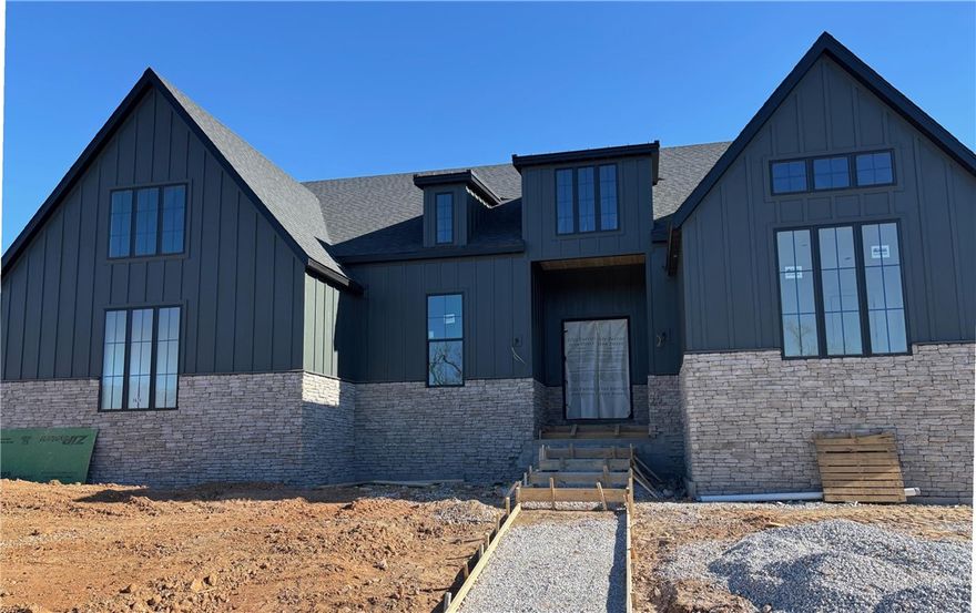 Built by the 2024 Parade of Homes Gold Medal winner! Feast your eyes on our one-story Carson floor plan.  This jaw dropping home is filled with luxurious finishes & sits on a large corner lot within walking distance to the community pavilion & green space. This home features a premium quartz waterfall kitchen island, oversized windows, & sliding glass doors, creating an outstanding indoor/outdoor entertaining space. The elegant main suite includes a separate tub & shower with floor-to-ceiling tile, dual shower heads, his/hers sinks on opposite sides of the bathroom as well as a separate office space. The home offers a bonus room that could double as a 5th bedroom, & a three-car garage. You'll find high-quality finishes throughout, such as quartz countertops, GE Cafe appliances, custom cabinetry, a "hidden" pantry, & soft-close cabinets with under-cabinet lighting.  Located just 2 miles from the Bella Vista by-pass, 5 miles from Coler Mtn, 7 miles from downtown Bentonville, & 8 miles from Wal Mart Home Offices!