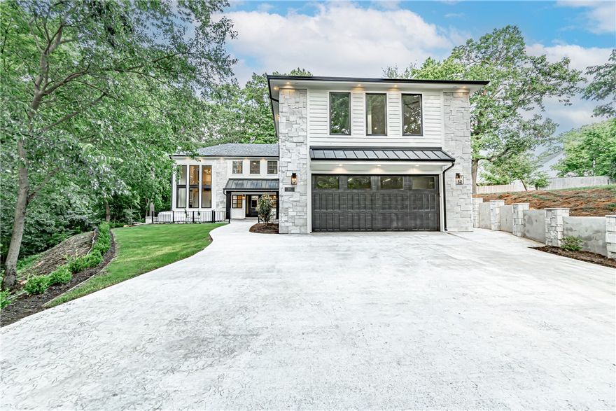 Modern new-build just blocks from Downtown Bentonville! This stunning open concept interior features an abundance of natural light, cathedral ceilings, beautiful hardwood flooring, and an eye-catching fireplace in the living space that opens into the spacious kitchen and dining area. This kitchen is a chef’s dream with its quartz countertops, gas range, and oversized island. The additional 1BR/1.5Bth apartment above the garage provides great rental opportunities or a mother in law suite. The outdoor portion of this property is great for entertaining with its pristine courtyard featuring a spacious outdoor living space. Enjoy the tree-house feel of this property with its wooded buffer with scenic onsite creek. Located just seconds away from Crystal Bridges Museum, the Downtown Square, and with direct access to miles of biking and walking trails, this home is in an ideal location. Welcome home!