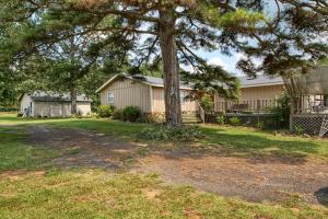 Lovely home on 4 fenced acres on a private dead end road. This peaceful setting would be perfect for a few horses or other livestock, or just a place to Play! Wraparound deck for enjoying the birds, and beautiful skylights inside for natural sunlight all day. This home boasts 3 large bedrooms and an office, a large living room and dining room, as well as a nice sized eat in kitchen with new appliances. Closets, closets and more closets... there is no lack of storage here! The shop is wired for 220, has concrete floors, shelving and added cabinetry. This place has it all!