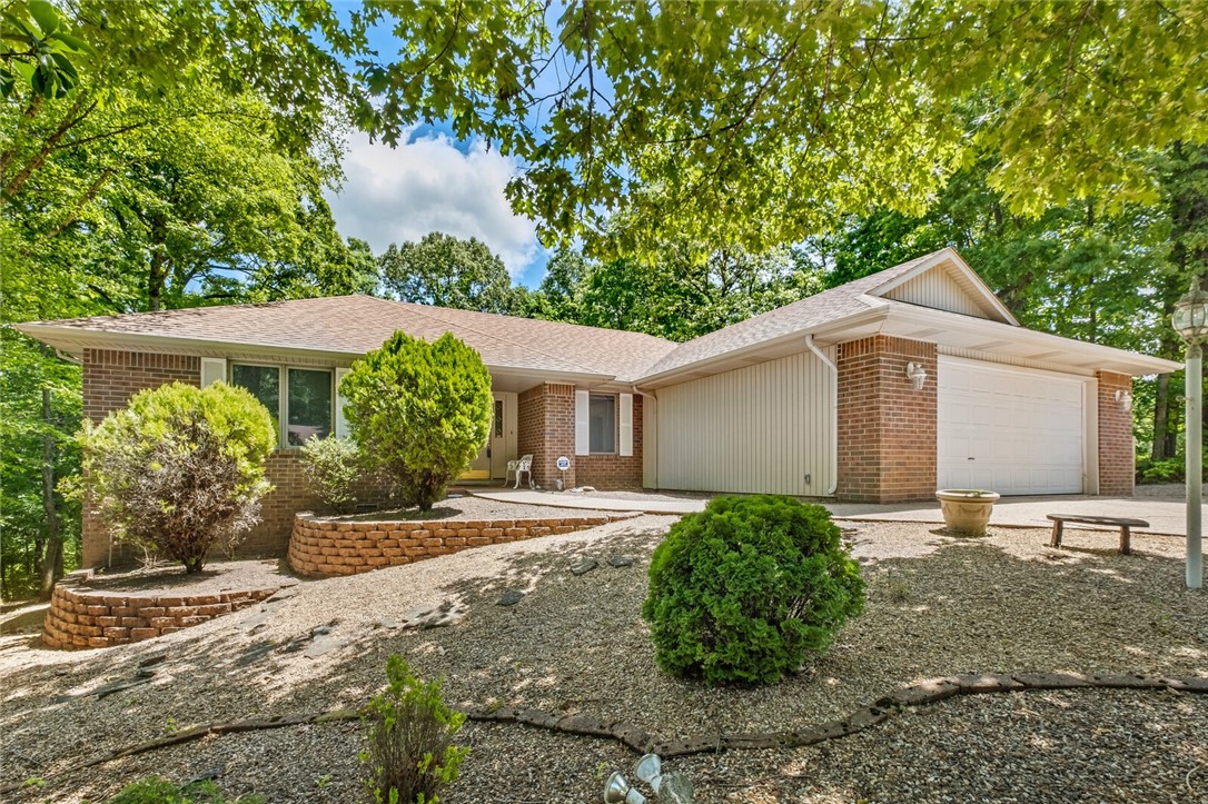 Experience the ideal setting for outdoor lovers. Just a short walk from the beautiful Beach at Lake Avalon, a mere two minutes to the Back 40 trails, and a quick bike ride to Tanyard Creek Nature Trails, this charming home is in a peaceful cul-de-sac, close to shopping, with easy highway access to I49 and 71 Business.
The home is bathed in natural light from the large casement windows. Relax in the enclosed sunporch while overlooking the private backyard, or step outside to the deck perched among the trees to enjoy the sounds of nature. The main living area includes a separate den. The primary bedroom suite has a spacious full bath, walk-in closet, and skylight. Lower-level partial basement . Home is move-in ready with fresh paint, professionally cleaned carpets, a recent epoxy garage floor, deep cleaned throughout. Conveys: refrigerator, washer, dryer, and owned propane tanks. Send Offer with preapproval, proof of funds to Peggyfowler1720@gmail.com