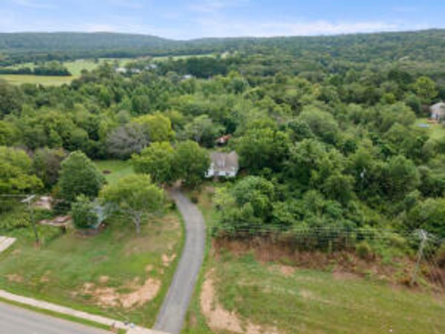 Historical home on approximately 9.9 acres on the edge of all of the potential commercial happenings of Russellville!