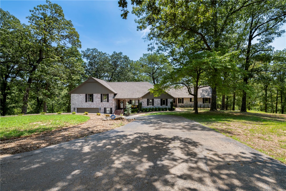 This mesmerizing Beaver Lake residence represents the pinnacle of upscale lakefront living, encompasses an entire point off Coose Cove and situated among 4.7 acres with over 450 ft of shoreline. This beautiful traditional 4,756 sqft, 5 bedroom lake home with lake views, has 1,260 sqft shop and a private dock too, a must see! Many recent upgrades and updates inside and out including new luxury laminate flooring on main level and paint which created a whole new look, then there is a new expanded composite deck,
expanded covered patio that created lots of outdoor living space, oh and new floats, lift, sea anchors on
dock and much more. So much space with formal living, secret room, office, open gourmet kitchen with
professional appliances, separate dining space, great room, walk out lower level with more space. Only 15 mins to Downtown Rogers, 25 mins to Wal-mart Off, convenient and close but yet tucked away from the stress and noise of busy streets! Call today and own a little piece of heaven on Beaver Lake.