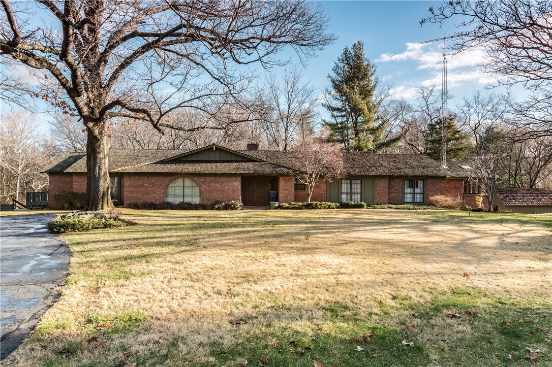 One of a kind! Downtown Bentonville 8.76ac w/Historic Significance & Beauty! Magnificent views of "Alice Valley" & Town Branch Creek which flows directly into the Crystal Bridges Museum grounds. Historic site of the 100yr old Macon-Carson Apple Brandy Distillery w/remnants still on the property. Private drive leading to a 4366sf estate home surrounded by Champion Oaks. Property has unique dev. potential for multiple building sites only steps from the Bentonville Square. Serious inquiries & by appt. only.