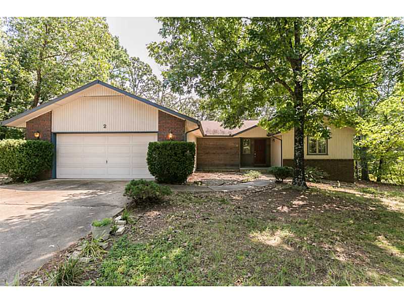 Clean home nestled in the trees of Bella Vista! Fresh paint, new fixtures, and the covered porch was just screened in. New lighting in living room, dining room, and bedrooms. Water heater was just installed last year! Large kitchen with lots of counter,and storage space! Large walk-in closet in master bedroom. Situated on a large lot with plenty of green space behind and ample space between the property and the neighbors. Very private! New roof to be installed.