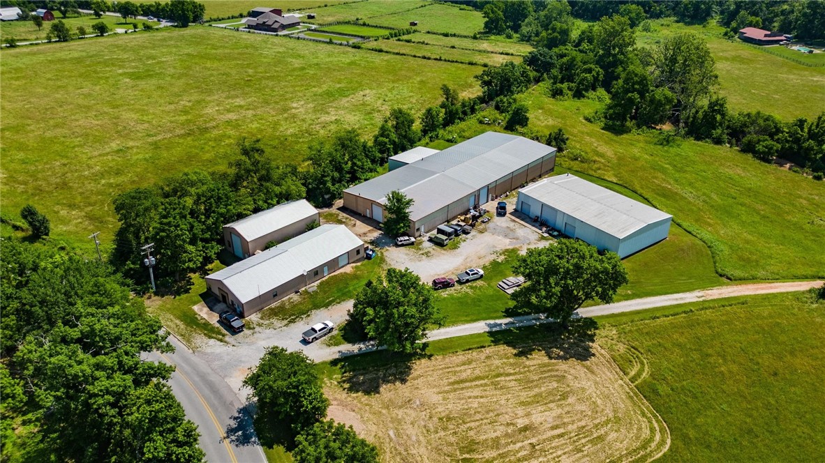 Unlock the full potential of your business with this multi-building industrial manufacturing facility in north Bentonville! Whether you're expanding an operation or looking to establish a highly functional base for production, this property offers the space, flexibility, & location to meet your needs. Large bays provide an ideal layout for equipment, heavy operations, or multi-department setup. Clear span interiors with high ceilings accommodate large equipment & vertical storage needs. Multiple overhead & dock doors offer convenient access for loading and unloading. Can handle high-capacity industrial power demands. Ceiling suspended utility lines support efficient operation of CNC machines, hydraulic presses, and more. 6-8" thick concrete floors ensure durability for heavy machinery such as forklifts, presses, mills, and lathes. A dedicated front area with private offices & conference room, that can be customized for administration or design/engineering needs. Close proximity to I-49 & Coler Mountain.