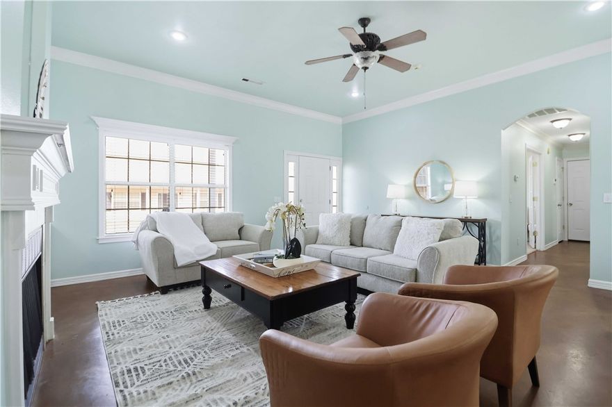 Dang cute doesn’t even begin to cover it! This thoughtfully designed 1,689 sq. ft. home feels peaceful, welcoming, and lives much larger than its footprint. Featuring three bedrooms plus a versatile bonus room with French doors and a closet, this flexible space can easily function as a fourth bedroom, home office, second living area, or creative studio. (I’ve even sold this exact floor plan where the bonus room was perfectly used for in-home daycare services!)

The open-concept living area flows seamlessly into the kitchen, showcasing built-ins and a cozy wood-burning fireplace that anchors the space. Stained concrete floors throughout the main living areas offer both style and easy maintenance, while brand-new carpet has recently been installed in all bedrooms for added comfort. Every square foot is utilized beautifully, creating a home that feels spacious, functional, and just plain happy.