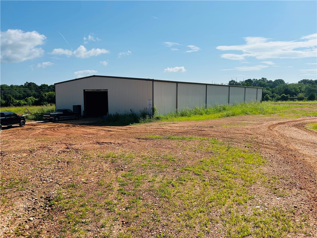 Approximately 14,000 square feet of sturdy red iron shop building with tall ceilings on 3.78 acres in an industrial area. This shop is currently being used for semi truck repair. Located right on 65 within city limits but with plenty of room and land for storage or for trucks parking or turning around. Reach out to me and lets talk about the possibilities with this shop!