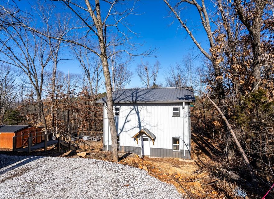 Unfinished new construction offering a rare opportunity to customize and complete your dream home just minutes from the lake, sitting on 1.03 acres. This approximately 1,400 SF home features 3 bedrooms, 1.5 baths, and a versatile upstairs loft ideal for a flex space or home office. Modern touches already in place include concrete floors, LED lighting, 12" walls, and an electric glass fireplace. French doors open to the deck, creating an easy indoor-outdoor flow. Located less than one mile from Rocky Branch Marina with quick, easy access to the lake—only a 2-minute drive. Property includes RV parking with full hookups, a frost-free hydrant, a 20x16 storage building, and a wooded setting with an additional wooded corner lot at Park Rd and Canary Rd. Bring your vision and finishing touches to make this property truly your own.