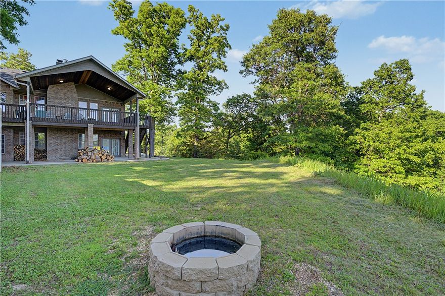 Acreage, views, Bentonville Schools, and rare flexibility make this Bella Vista property one you don’t see every day. Sitting on 3.17 total acres and not part of the POA, this home offers a rare Bella Vista setting without the typical POA restrictions. Inside, the craftsmanship stands out with hickory cabinets, white oak living room ceilings and baseboards, detailed woodwork, and two wood-burning fireplaces. The walkout basement adds even more versatility with a bedroom, full bath, large second living area, epoxy-coated concrete floors, extra storage, and a completely separate lower-level garage/workshop area. With its own garage door access and electrical hookups, this space is ideal for bikes, tools, EV charging, or hobby projects. Recent updates include a 2024 roof, 2025 double oven and gas cooktop, and well-water filtration system. The subdivided parcel has its own address and electric meter, creating future possibilities — buyer to verify permitted uses.  See attached features sheet for additional details.