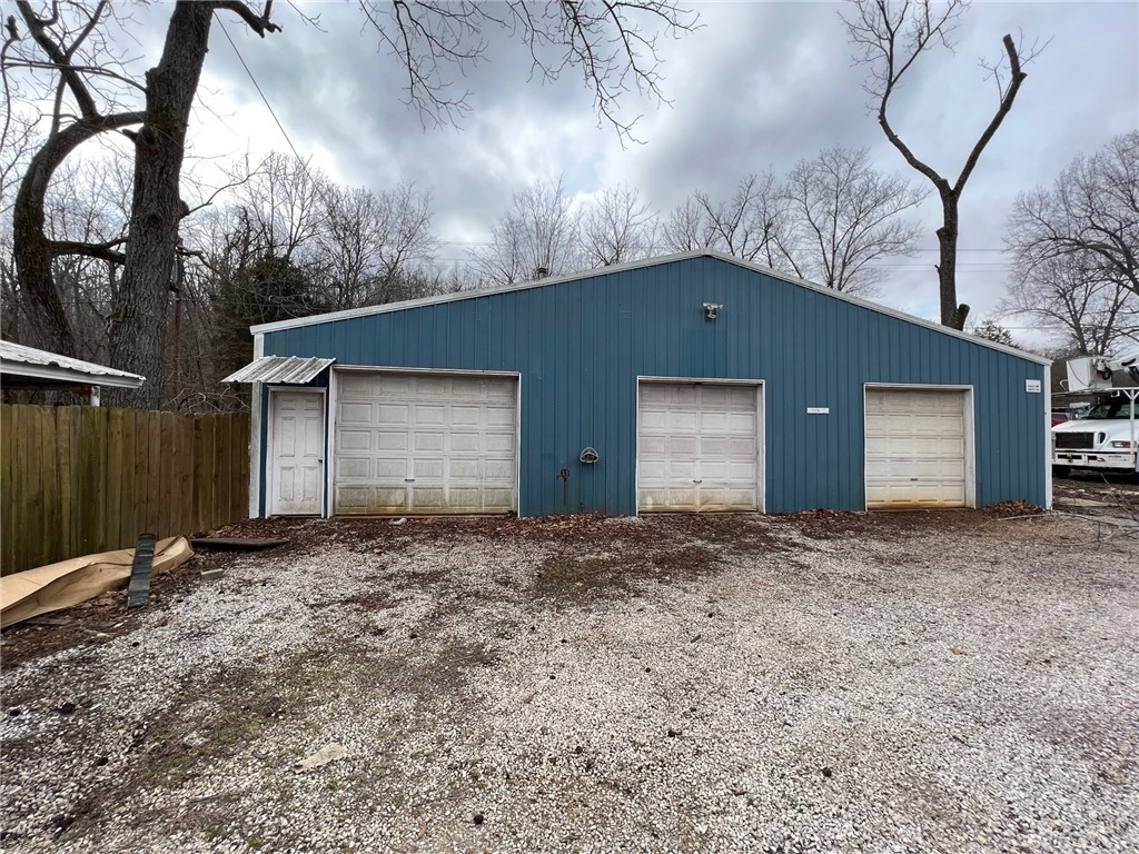 Metal building with three overhead doors. Water and electrical on site.