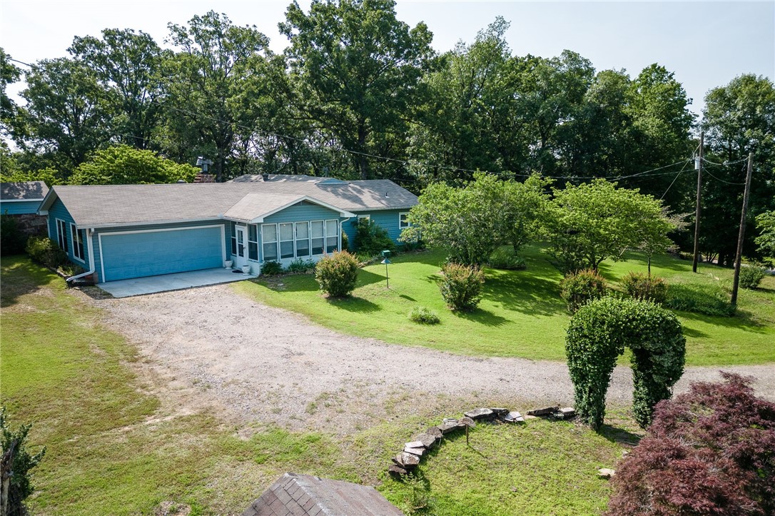 Well loved & maintained home with 3 bedrooms, 3 baths, 2 living areas, 60x40 shop with rec room, tool shed, rock 2 story building(hobby or craft) gorgeous flowers everywhere! Has well that was used before rural water. WB fireplace, plus wood stove in one living area/dining. Roof in 2015, HVAC 2021, duct work in 2022, septic cleaned in 2021. Must see to appreciate.