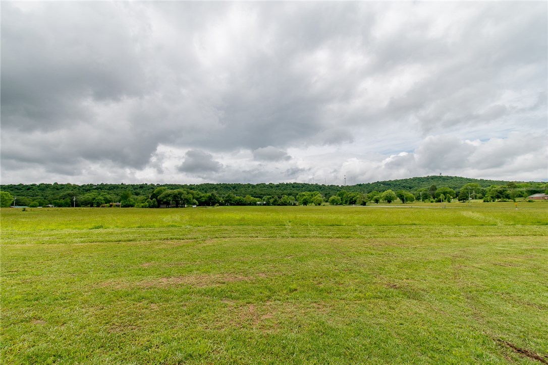 Great building site on this 7.76 acres for your custom home. All pasture. Building site sits at elevation above the road. Topography is mostly level with very gentle roll. Located on a corner with lots of road frontage. Perfect for estate, ranchette or hobby farm. Located within city limits. Zoned A-1 (Agriculture) allows for horses and such. Gas & water at street. Close to school. Country living within the city limits!
