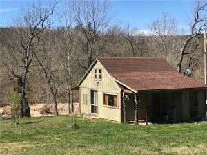 Sit on the back deck and listen to the creek flow. This homey rustic hideaway truly lets you escape from the world. Situated on 6 acres, there's lots of room for a garden, with woods, pasture and Keels Creek frontage. Designed to be simple and minimal, it offers a well and electric, wood stove and mini-split hvac system. Currently uses composting toilet, but has been perked for septic system.