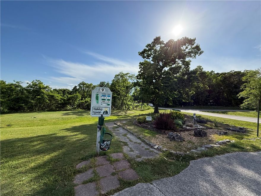 Welcome to your next adventure in Holiday Island—where fun meets fairway! This beautifully flat, easy-to-build corner lot is the kind of find that makes you do a double take. Tucked among the trees for a peaceful, tucked-away feel, yet open and level enough to bring your dream home to life without the hassle. From the corner, enjoy a glimpse of the golf course and imagine mornings with coffee and evenings with sunset views just a swing away. Located near the main entrance and clubhouse, you’re close to the action while still enjoying that “escape from it all” vibe. Whether you’re dreaming big or building smart, this lot is ready to play—are you?