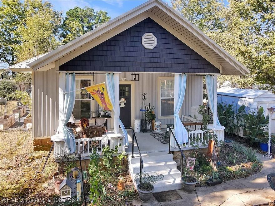Perfectly centered in the walkable heart of historic Hartford, Arkansas—just steps from the post office and city hall. Built with early 20th-century bones and reborn with thoughtful custom design, this single-level retreat radiates authentic farmhouse vibes while delivering move-in-ready comfort. Step inside to warm flooring, and a split-bedroom layout that maximizes privacy. The open living area flows seamlessly into a bright kitchen and ample storage. Both bathrooms shine with modern fixtures, while built-in shelving, a dedicated mudroom, and ceiling fans throughout add everyday ease. Unwind on the relaxing covered front porch, complete with space for rocking chairs and fluttering curtains to frame the small-town views. The fully fenced backyard is an entertainer’s dream, plus a handy storage building for tools, bikes, or holiday décor. Multiple garden areas hug the perimeter—raised beds already prepped for vegetables, herbs, and flowers—inviting you to dig in and grow your own homestead bounty.