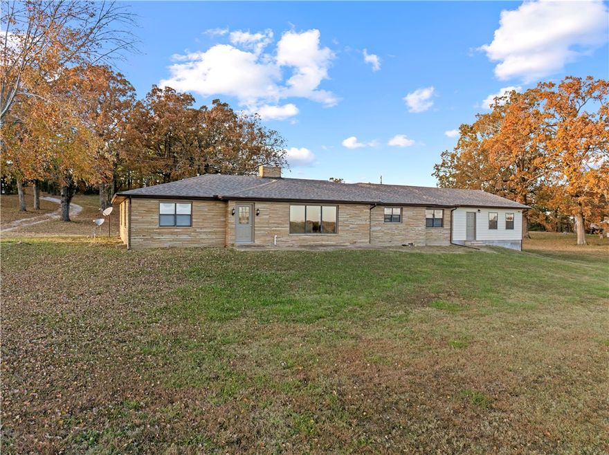 Welcome to peaceful country living in the heart of the Ozarks! This inviting 3-bedroom, 2 bath home rests on 3.5 acres m/l (MLS# 1328025 for 20 acres) surrounded by beautiful rolling pasture. Inside, the home offers a warm, comfortable layout with natural light and easy flow to the outdoors. With a new roof installed (summer 2025), recently refinished hardwood floors throughout, updated bathrooms, new HVAC, new electric and updated plumbing this home is move-in ready! A fully insulated owners dream shop building includes 3 large bays, a half bath, a propane heater, and electricity. Whether you’re sipping coffee on the porch, tending a garden, or taking in the beautiful views, this place invites you to slow down and savor simple living. A rare blend of comfort, privacy, and the natural beauty of rural Arkansas living.