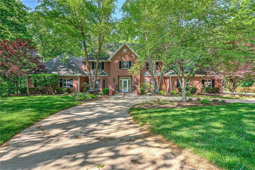 OWN YOUR OWN LITTLE SLICE OF PARADISE TUCKED AWAY ON A PRIVATE 2.92 ACRE LUSH SETTING W/ FRONT CIRCLE DIVE, GORGEOUS CURB APPEAL, IN-GROUND POOL, CHARMING POOLSIDE PERGOLA PLUS A DETACHED 1,000 SQ FT GUEST HOUSE COMPLETE WITH LARGE LIVING AREA, FULL KITCHEN, BEDROOM, BATH, LAUNDRY ROOM AND CARPORT CREATING GREAT INCOME POTENTIAL!!  Just 3 miles from DOWTOWN BENTONVILLE and minutes from trails and I-49 making this a FABULOUS location! The home has been meticulously maintained & offers lots of updates including NEW CARPET, NEW PAINT throughout including kitchen cabinets, NEWLY RENFINISHED beautiful hardwood floors, NEWER light fixtures, NEW dishwasher and NEW washer & dryer to convey with home! Open kitchen/living/dining area walks out to a beautiful screened porch taking in the serene & completely private back views! Large formal dining, 3 living areas, dedicated office/study, main level primary suite w/ updated en suite bath w/ His/Her walk-in closets, grand foyer & 2 staircases! This little GEM has it all!