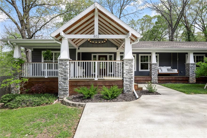 Not far from Downtown Bentonville, trails / bike paths & very close to I-49, this newer 2020 1-story, full hardie board, craftsman & traditional styled home is privately situated in a woodsy setting on almost half an acre, w/4-bedrooms, 3-baths, 2-car attached roomy garage, landscaped front yard w/large covered porch that boasts an oversized comfy porch swing/wood beamed cathedral ceiling/circle wrought iron chandelier, & an open backyard deck, wooded views from front or back yards, shed for lawn equipment/storage/or make it a he/she shed, entry foyer leads into open living room/dining/kitchen areas, butler pantry & separate laundry room both w/barn doors & located between the kitchen & primary suite, big kitchen island for food prep & dining space, gas burner stove w/pot-filler faucet, appliances convey, closet built-ins, extra gravel parking.  So many features too numerous to mention, this is a must see.  Roof, HVAC system & Hot Water Tank from 2019-2020, in working condition & Seller offering a Home Warranty.