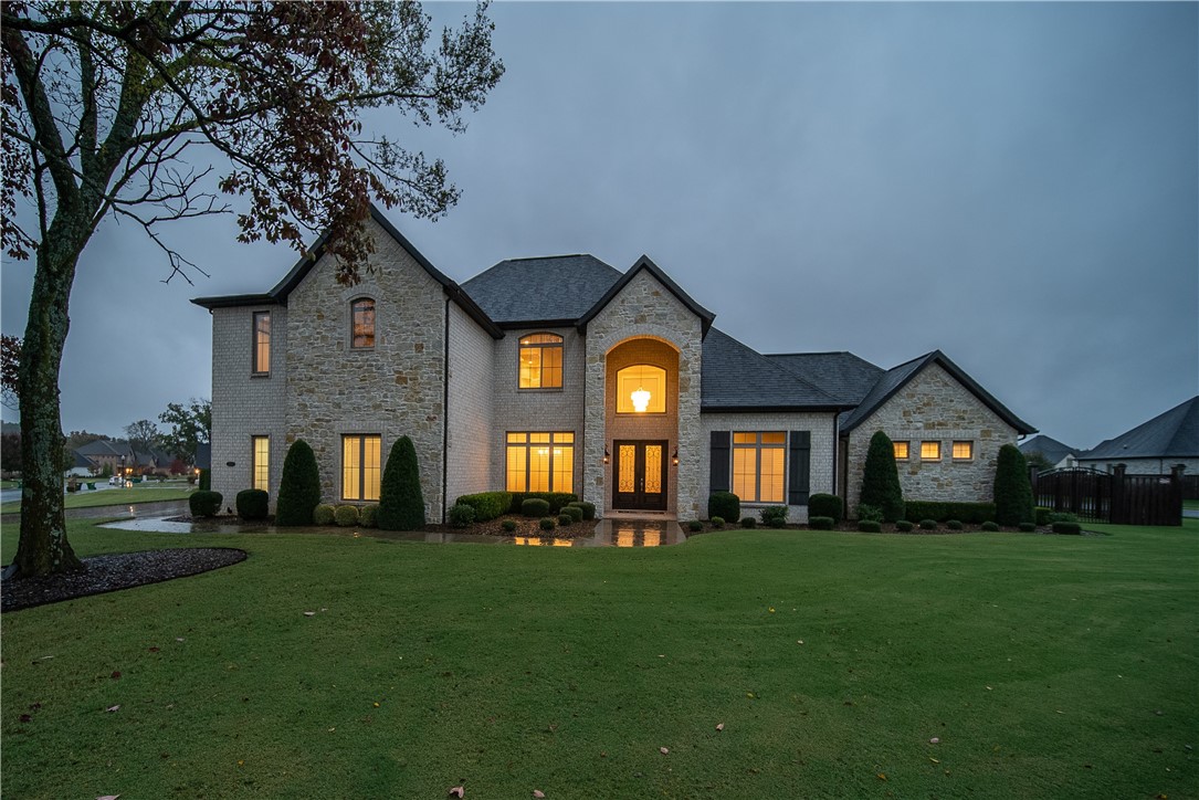 Not one detail was missed for entertaining and comfortable living in this captivating estate home. 1st. Floor features include a fully equipped gourmet eat-in kitchen, large family room/gas log fireplace, wine room, formal dining, luxurious master suite, study, half bath, utility, plus a second master suite with its own bath and garage access. 2nd Floor features 3 bedrooms, 2 baths, theater room with all equipment, plus another family room, built-in bar, second laundry in hallway. Covered back patio with fireplace and built-in grill. Four car garage, huge fenced yard. Desirable corner double lot. Gated community/pool & tennis courts, close to Elementary & Bentonville West High School.