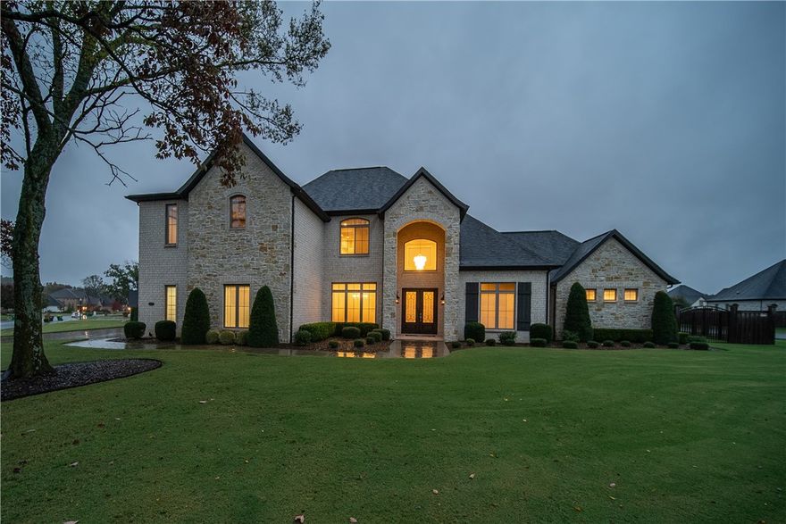 Not one detail was missed for entertaining and comfortable living in this captivating estate home.  1st. Floor features include a fully equipped gourmet eat-in kitchen, large family room/gas log fireplace, wine room, formal dining, luxurious master suite, study, half bath, utility, plus a second master suite with its own bath and garage access.  2nd Floor features 3 bedrooms, 2 baths, theater room with all equipment, plus another family room, built-in bar, second laundry in hallway. Covered back patio with fireplace and built-in grill.  Four car garage, huge fenced yard.  Desirable corner double lot. Gated community/pool & tennis courts, close to Elementary & Bentonville West High School.