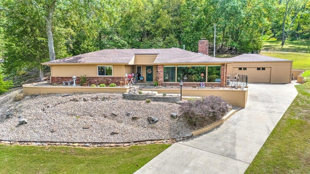 Move to Your Own Nature Preserve! Experience peace and tranquility in this beautifully remodeled 3-bedroom, 2-bath home located in serene Prairie Creek, complete with seasonal views of Beaver Lake. With 2,566 sq ft of living space on a spacious .61-acre lot, this home is a true retreat. Abundant natural light fills the open living areas, highlighting the beautiful hardwood floors. Enjoy the warmth of a wood-burning fireplace, perfect for those chilly evenings. Huge bonus room. Oversized garage provides ample storage. Solid Ash Lathem built cabinets w/ new self-close hardware. Step outside to your own private courtyardāideal for outdoor gatherings or quiet moments. Newer roof and HVAC systems ensure comfort and efficiency. Bonus: Enjoy deeded lake access for all your outdoor adventures!