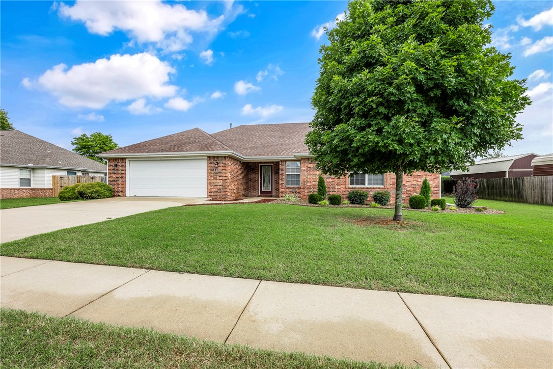 3BR/2BA brick home on a large landscaped lot directly behind Pea Ridge City Park. Spacious open layout with cozy brick fireplace, eat-in kitchen with newer upgraded stainless steel KitchenAid appliances including refrigerator, custom-built solid oak cabinets, built-ins, and trim throughout. Oversized 2-car garage is heated & cooled—great for hobbies, projects, or storage. Enjoy two covered patios, one extended into the yard for extra seating or a fire pit, wood privacy fence, and a storage shed in the backyard. Primary suite features dual sinks, jetted tub, and separate shower. Move-in ready with plenty of indoor and outdoor living space!