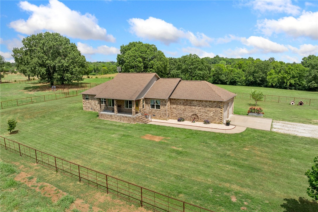 Newer brick home on 16 acres in the Valley Springs School District with a peaceful, park-like setting. This 2 bed, 2 bath home plus office features hardwood floors, granite countertops, gas fireplace, large closets, excellent storage, and a spacious laundry room. The primary suite offers a walk-in tiled shower. Enjoy a covered front porch with views of Boat Mountain and a tiled back patio for relaxing or entertaining. Updates include a new HVAC in 2022, plus natural gas, Generac backup generator, and a storm shelter inside the 2-car garage. Outside youāll find a 40x60 insulated red iron shop with concrete floor and ½ bathābring your boat, RV, or SxS, thereās room for it all! The property also offers a pond, corral, and over 3,500 ft of pipe fencing. Conveniently located on a paved road less than 5 miles from downtown Harrison, this property is move-in ready and built for both comfort and functionality.