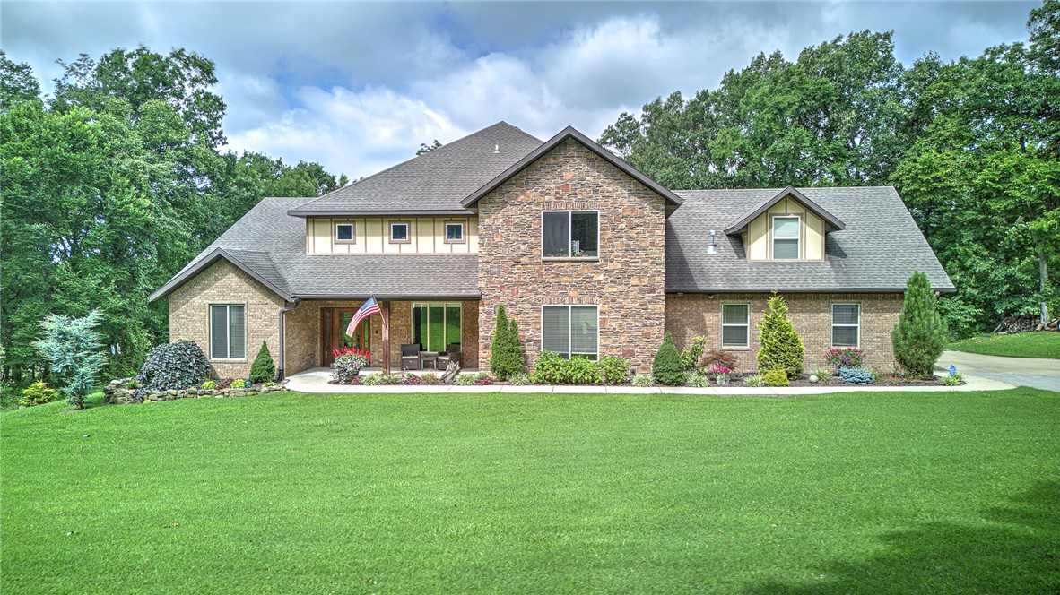 Craftsman-style home with covered porch, a front y