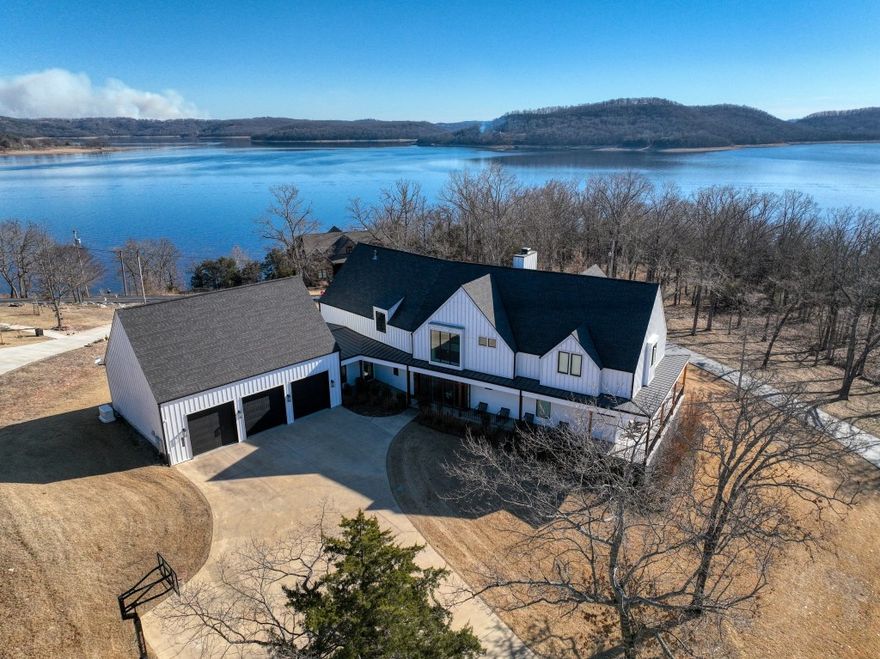 It’s easy to see why this recently constructed home was nominated for HGTV Best Waterside Retreat for 2022. It is a drop-dead gorgeous! Every surface is high-end and in excellent condition! This beautiful flat lot is a part of Del Lago Estates, one of the most sought-after gated subdivisions on Beaver Lake. Bring your friends and toys because two boat slips in the Del Lago community dock are included and are very close-by. Amazing details are everywhere, including two multi panel sliding glass doors which open the whole corner of the dining room and allow access to the huge screened-in patio! The stylish lower level also holds the large master suite and study. A floating staircase leads upstairs to the overhead cat-walk, a second large bedroom suite, and three other bedrooms. A large TV room and game room offer endless fun! You’ll love the oversized 3 car garage with it’s pull-through door that eliminates trailer backing. And the icing on this cake are the furnishings and furniture that are included!