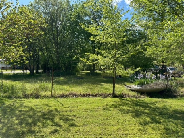 1.16 acres. Level ground with nice trees. Electric, public water and septic on site. Old mobile home that needs to be removed on site. Do not enter.