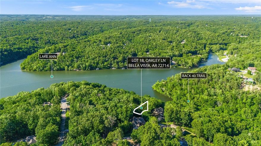 Rare opportunity to own a .34-acre lake view lot with direct access to common property that leads to Lake Ann—perfect for nature lovers, paddlers, or those dreaming of a peaceful backyard oasis. Located just steps from the Buckingham trailhead on the Back 40 Trail System, this lot is a dream for mountain bikers, hikers, and outdoor enthusiasts. Gently sloped and surrounded by natural beauty, it's an ideal site for your future home or getaway cabin. Enjoy the serenity of Bella Vista living with close access to world-class trails, lakes, and all POA amenities. Recent perc test completed with excellent results!