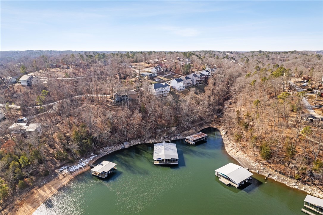 Is having fun and making memories high on your priority list? We have found the perfect home for doing just that! This lakefront home offers plenty of space for family and friends to enjoy beautiful sunsets, playing in the lake from your community boat dock, fishing, swimming, and more. With 5 bedrooms and 4 full baths, plus two living areas and two kitchens, it’s great for second living quarters that can be locked off for short-term rentals. Enjoy year-round lake views from the trek decking. This home is truly the perfect place to live life at its best! With ample room for gatherings, this property invites you to create unforgettable moments. Whether it's a summer getaway or a permanent residence, this home ensures comfort and convenience. The possibility of short-term rentals adds an extra layer of flexibility and income potential. Don't miss out on this exceptional opportunity to indulge in the ultimate lakefront lifestyle. Both AC units were replaced in 2022, and the ductwork was rerouted and updated in 2024.