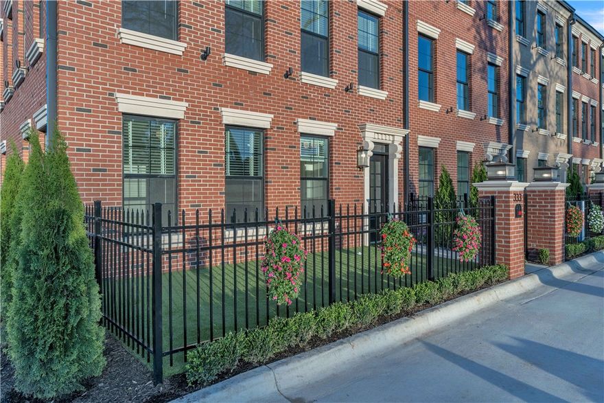 Oak One's Premiere Unit! The corner unit, painted white, all the windows and views!, an elevator, and most spacious 25ft wide!... Step into the epitome of luxury and elegance at Oak One, where these Bostonian-classic inspired brownstones redefine upscale urban-living in downtown Bentonville. Each residence exemplifies unparalleled craftsmanship and attention to detail, from the majestic cast stone and brick exteriors to the exclusive private green space courtyards. Designed for discerning tastes, these homes feature herringbone hardwood floors, solid core custom doors, and high-end finishes including 24k-gold plated light fixtures and a stunning 1000-light teardrop chandelier. Indulge in the pinnacle of convenience with touches such as Hansgrohe faucets/shower-heads, high-end smart toilets & mirrors, heated towel racks, and inset LG appliances. Enjoy a lifestyle of sophistication steps away from some of Bentonville's most iconic landmarks such as the Ledger, Pedaler’s Pub, the adjacent bike trail & more!