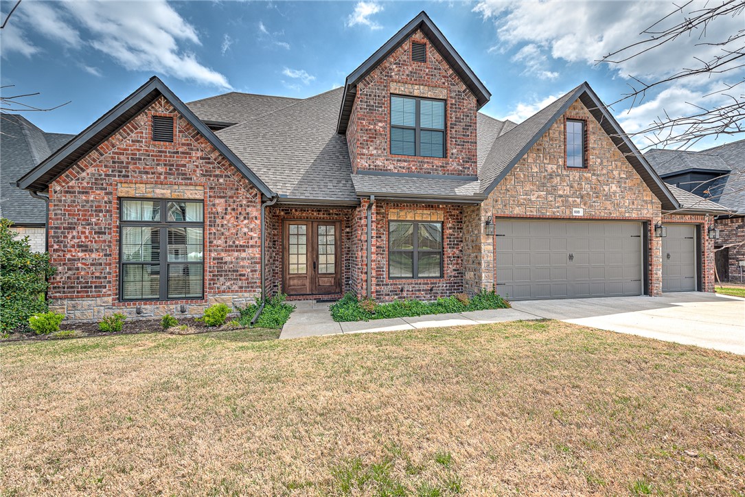 Nestled in Woods Creek, this 5-bedroom beauty could also be 4 bedrooms with a bonus. Dedicated office, formal dining, kitchen, and eat-in are on main level with primary suite. All other bedrooms on second level. Upscale design and finishes elevate the spaces. Exposed beams and other architectural details help set this home apart. Custom patio in back yard is perfect for entertaining. Home is located near community pool & amenities, in the heart of the neighborhood, which is conveniently located near new Walmart home office and I49. New roof in 2024. Come see all the āwowā this property has to offer!