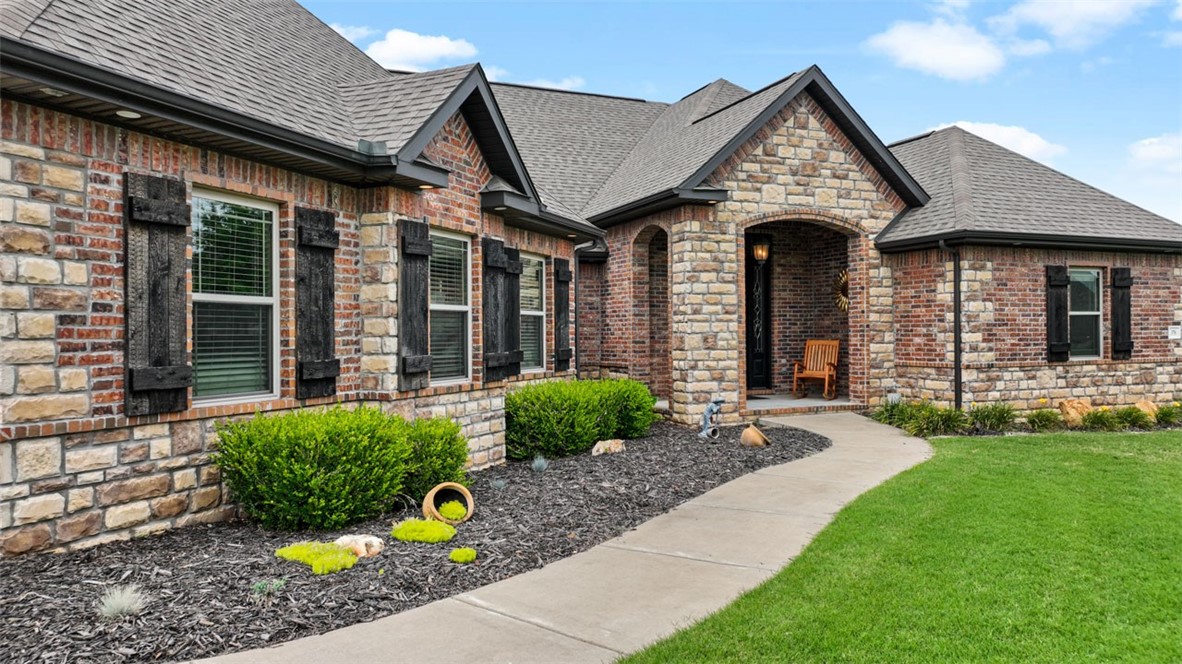Estate living at it's finest on over an acre just 12 minutes from the University of Arkansas. This all brick beauty is designed for entertainment inside and out. Everyone knows the kitchen is the heart of the home, and this entertainers kitchen is perfect for the role. Cook for a crowd with your Viking double oven, Wolf five burner gas cook top, and pot filling faucet. The huge farmhouse sink has plenty of room for your oversized pans. The enormous living room boasts a beautiful fireplace, but for intimate gatherings and conversations, you'll love the sunroom with it's own cozy fireplace as well. The split floor plan provides privacy for everyone, and guests will appreciate the second primary bed/bath! The office/den has a gorgeous built-in library and separate entrance, perfect for a home business. Then there's the backyard! You'll spend those sultry summer days/nights in the gazebo and covered patio by the salt-water gunite pool with it's own waterfall and slide! Schedule your personal tour today!