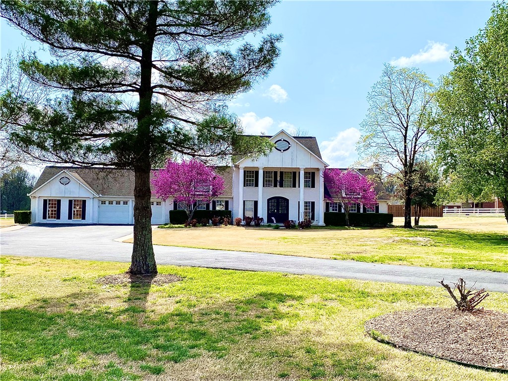 This beautiful, updated, unique home has 4 bedrooms, 3 full bathrooms, 2 half baths and sits on approximately 2.3 acres in West Fayetteville. Chef's kitchen is perfect for large family gatherings and pool-side entertainment. Kitchen boasts large gas cooktop with vented hood, double ovens, built-in ice maker, microwave drawer, bar seating for 8 and more. Oversized master suite opens directly to the attached, heated/cooled garage providing a unique layout. En-suite bath has free-standing whirlpool tub, large, tiled shower, separate sinks, and walk-in closets. Private media room with projector, electronic screen, wet bar, half bath and access to patio and pool. Entertainer's backyard boasts covered back patio, saltwater pool, vine covered pergola and detached cabana with wood burning fireplace. Upstairs has three bedrooms plus lots of extra space. Property also includes 1,400 sq. ft detached workshop garage with large, upstairs loft space (not included in house sf)
