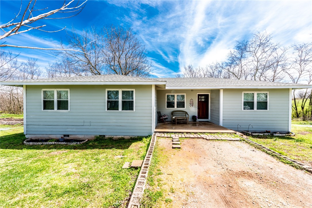 Home Sweet Home! Featured on 1.57 acres this 3BD/2BA home includes a front covered porch, wood laminate & tile flooring throughout, spacious living room, open eat-in kitchen kitchen w/ granite counter tops, backsplash, island, abundant creamy white cabinetry & SS appliances, large Master Bedroom, additional spacious bedrooms with wood laminate throughout, 2 tiled full baths w/ over sized vanities, spacious tree studded backyard overlooking beautiful mountain views! 30x24 shop & 8x8 storage building!