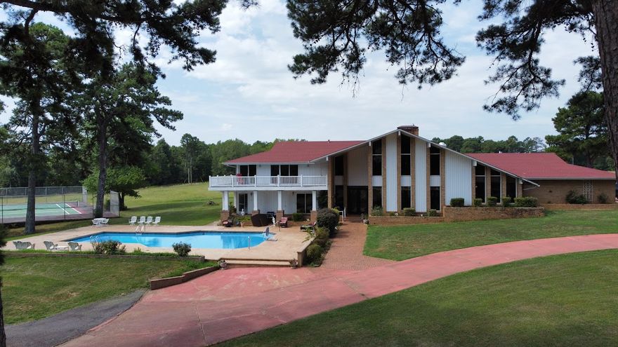 One of a kind. There's so much to this property it is hard to list it all. Including 2 homes. The main house is an original designed by well known architect is 5,258 sq ft heated and cooled. This one includes 5 bedrooms, 6 bathrooms, 2 living areas ,not just one but 2 floor to ceiling brick fireplaces. The master has its own balcony, and the master bath has 2 separate identical sinks and counter tops and master tub big enough to swim in, a wet bar, an indoor sauna, an inground 9 ft swimming pool, 2 upper deck (to see the amazing view of the mountains) 4 car garage, tennis court, a barn and much more.

The guest house is a cute cottage that has 3 bedroom 1 bathroom. 

The property has 2 ponds and thousands of yards of white fencing. It is not far from the national forest, the Arkansas River, and local lakes. There's bike trails, ATV trails, hiking trails everywhere in this part of Arkansas