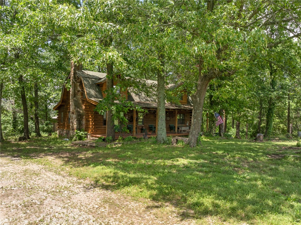 Ever wanted to live in a true log cabin? Well then look no more. Step inside this warm and inviting home that features exposed beams, rich wood finishes, and a living area that’s ideal for entertaining or cozy nights by the fire. The well-appointed kitchen includes ample cabinetry and counter space, while the spacious bedrooms and two full bathrooms provide plenty of room for family or guests. And with a 6k sq ft shop you have room for a home based business, a car collection, woodworking, or just extra storage. Enjoy total privacy, room to roam, and a lifestyle that’s both self-sufficient and serene—all just a short drive from town amenities.