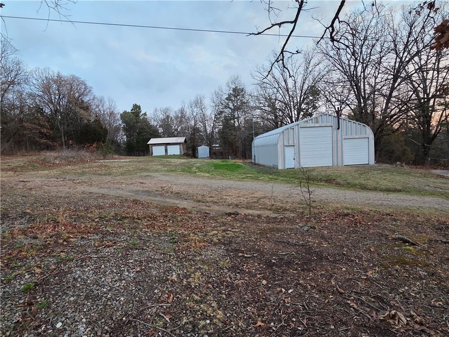 Prime location 2 miles to Eureka Springs & 4 miles to Berryville. Two side-by-side lots (1.3ac & 1.2ac) w/ Hwy 62 frontage, & a 1.5ac lot joining behind at end of short county road. All lots have well water access & gas line availability.  The 1.3-acre is served by 30+ft. asphalt apron off HWY & features a 30x40 metal shop on concrete slab w/ 2 roll-up doors. Inside is shop space, 1-bedroom, 1-bathroom living quarters w/ appliances, window AC, & propane wall heater. Shop space also has propane hookup, 220V Electric, wood stove, & massive amount of loft storage. Shop/Living quarters and the 2 RV spots served by full septic system. Also features a 24x24 2-car garage on concrete slab, 2 RV set-up spots w/electric, water, & sewer dump. Minutes away from Kings River & Beaver Lake. Only 45+ minutes to Branson, MO. & Table Rock Lake. If you're looking for a workshop, home building site, home base for RV, Commercial venture, or multi-lot investment, this property offers incredible infrastructure in a high-visibility area.