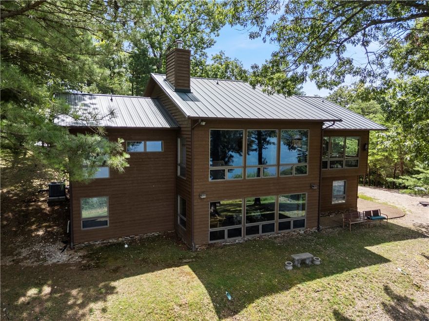 Wake up to breathtaking Beaver Lake views every morning in this exquisite luxury estate, a rare opportunity to own a piece of paradise.  The gourmet kitchen equipped with stainless steel appliances and a large island, is perfect for entertaining. Enjoy relaxing on the expansive deck, what a perfect way to start or end the day.  This spacious,well maintained 4000 sq. ft home features 5 bedrooms, 3.5 Baths with solid marble countertops, 2 living areas, large garage, bonus room over the garage, double ovens, solid doors throughout, 2 woodburning fireplaces, LR fireplace is vented into the primary BR, Lower level Fireplace is soapstone and will keep the whole house cozy, metal roof, generator and so much more!   Private well and septic.  Large open yard with a firepit and plenty of room for the whole family.  This spectacular home is well situated on 3 acres. Additional bonus to this beautiful home is that it is selling fully furnished! *note a few perso items do not conv.This is a must see, you will not want to leave!