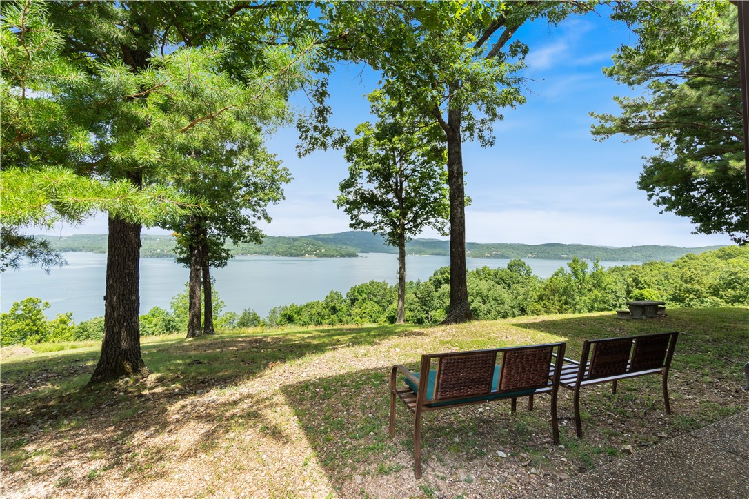 Wake up to breathtaking Beaver Lake views every morning in this exquisite luxury estate, a rare opportunity to own a piece of paradise. The gourmet kitchen equipped with stainless steel appliances and a large island, is perfect for entertaining. Enjoy relaxing on the expansive deck, what a perfect way to start or end the day. This spacious,well maintained 4000 sq. ft home features 5 bedrooms, 3.5 Baths with solid marble countertops, 2 living areas, large garage, bonus room over the garage, double ovens, solid doors throughout, 2 woodburning fireplaces, LR fireplace is vented into the primary BR, Lower level Fireplace is soapstone and will keep the whole house cozy, metal roof, generator and so much more! Private well and septic. Large open yard with a firepit and plenty of room for the whole family. This spectacular home is well situated on 3 acres. Additional bonus to this beautiful home is that it is selling fully furnished! *note a few perso items do not conv.This is a must see, you will not want to leave!