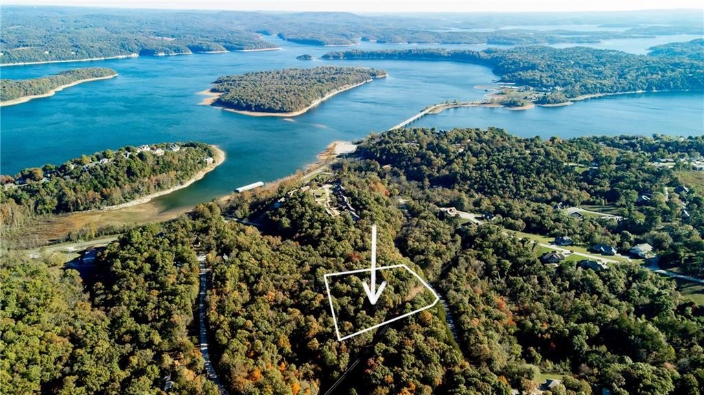 Looking for the perfect spot to build your dream home near Beaver Lake? This lot is just a half-mile from the Hwy 12 boat ramp, offering easy access to water and the convenience of being minutes from Rogers. Enjoy the peaceful rural setting without sacrificing proximity to city amenities. With fiber optics, electricity already in place, and no HOA fees, it's a rare find in a desirable area.