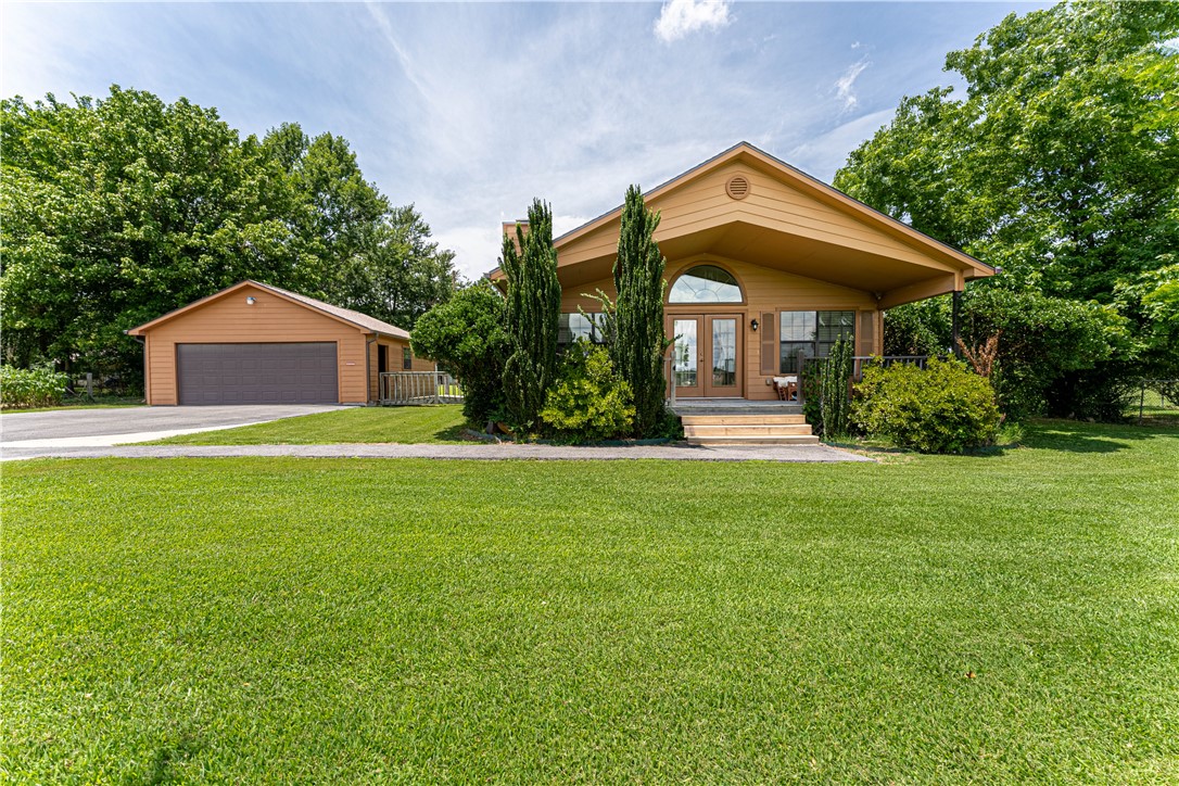 Country living in Springdale on 1.24 acres! This one-of-a-kind custom craftsman home built by United-Bilt Homes is now available for sale. Built in 2011 this 3 bedroom, 2 full bath single family home features custom built cabinetry (with pull out drawers) and island in an open, spacious kitchen. Large ceramic tiles are featured in all areas except the carpeted bedrooms. The vaulted ceiling and large windows provide natural light and a feeling of spaciousness in the living room. The dining area overlooks the front porch and yard. New roof in 2022. New dishwasher in 2023. All interior walls are insulated. Large master bedroom has a ceiling fan. Master bath has stand-up shower, jacuzzi tub, 2 separate vanity sinks, walk-in closet. A sweet walking bridge connects the house to the garage. Huge, open back yard, mature trees. 2-car garage, shed & carport.