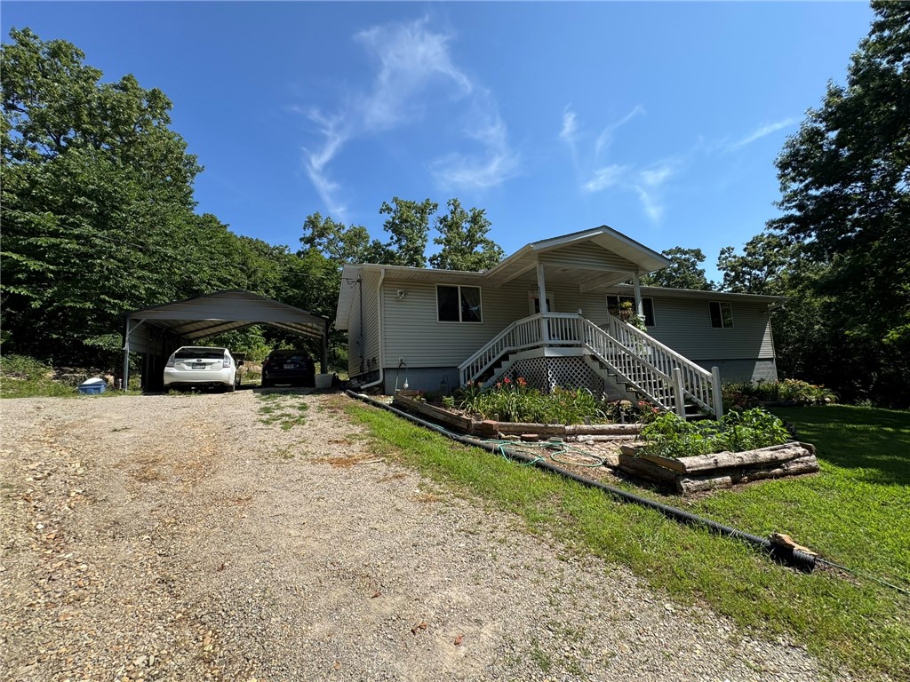 SECLUSION, PRIVACY, AND A NATURE LOVERS DREAM BEST DESCRIBES THIS WONDERFUL COUNTRY PROPERTY. THIS 3 BEDROOM/ 2 BATH HOME SITTING ON ALMOST 13 AC/ML FEATURES A SPLIT BEDROOM PLAN, WELL DESIGNED KITCHEN, DINING AREA, AND A SPACIOUS LAUNDRY ROOM, PLUS WALK IN CLOSETS IN EVERY BEDROOM. ENJOY A WOODED COUNTRY VIEW FROM THE COVERED FRONT PORCH, OR THE ROCK FEATURES AND RAISED GARDENS FROM THE BACK SCREENED IN COVERED DECK. OUTSIDE, TWO 2-CAR CARPORTS, A STORAGE SHED, AND A GREENHOUSE. RECENT UPDATES HAVE BEEN MADE TO THE FRONT & SIDE STAIRS, PLUS THE STAIRS OF THE BACK DECK. THE HOME SITS WELL BACK FROM THE COUNTY ROAD, OFFERING PLENTY OF PRIVACY. CENTRALLY LOCATED BETWEEN BULL SHOALS LAKE AND NORFORK LAKE ACCESS. MINUTES FROM WHITE RIVER ACCESS.